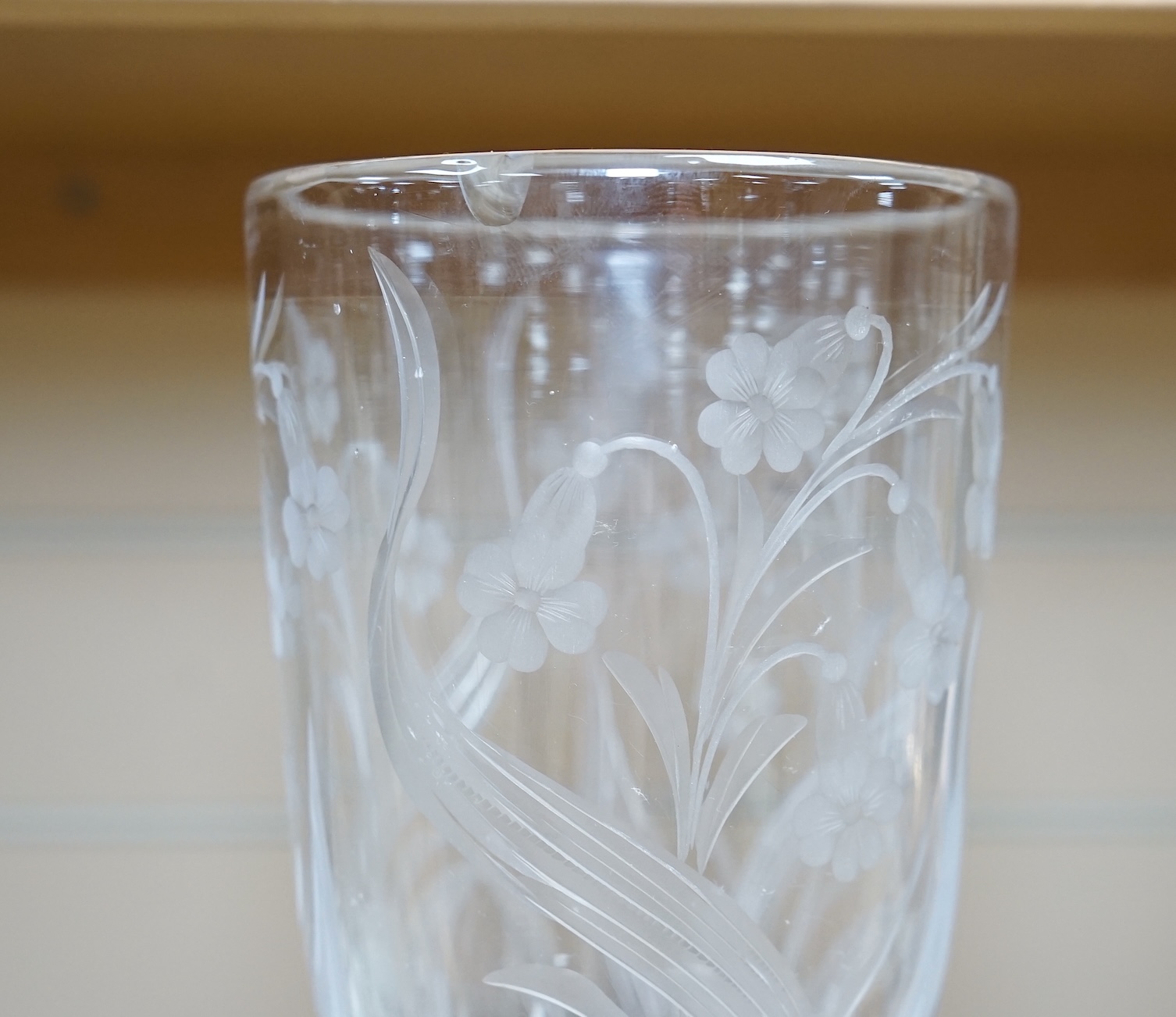 A large ‘floral’ engraved glass flute, 29.5cm. Condition - chip to upper rim